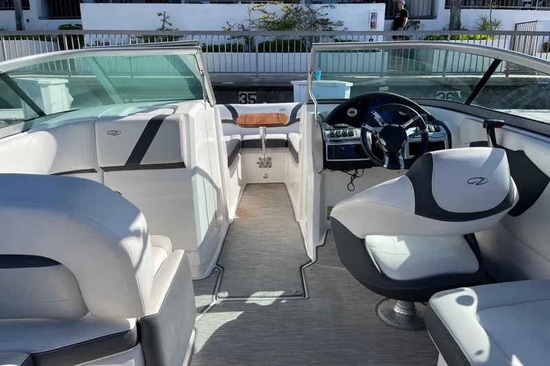Slide: The Image of Interior of a 2016 Regal 23 OBX boat with modern seating and steering wheel. - 17
