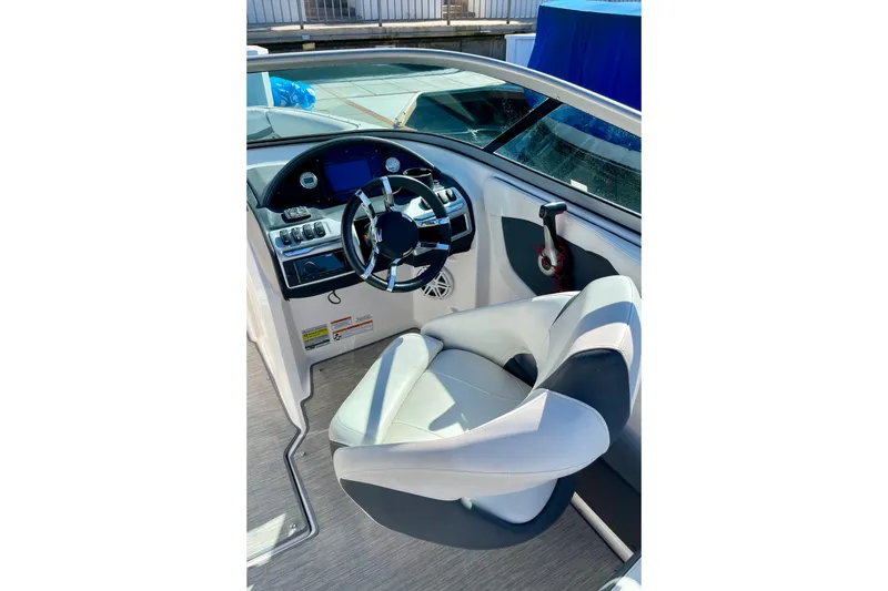 Slide: The Image of 2016 Regal 23 OBX boat cockpit with modern steering and comfortable seating. - 18