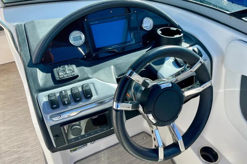 Slide: The Image of Steering console of a 2016 Regal 23 OBX boat with modern controls and display. - 19