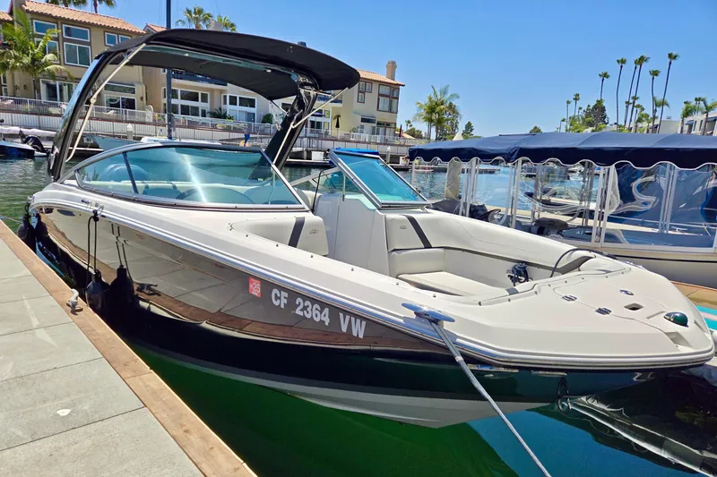 Slide: The Image of 2016 Regal 23 OBX boat docked in sunny marina setting. - 2