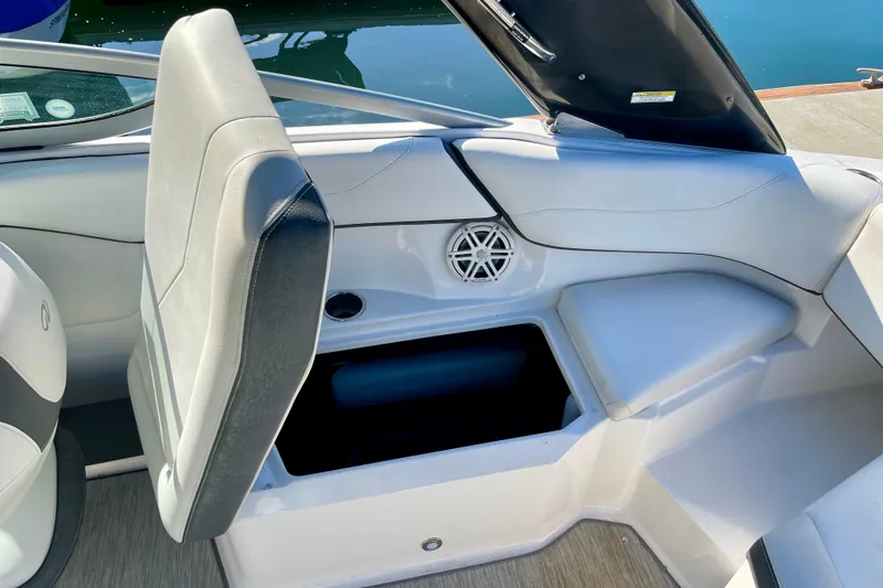 Slide: The Image of 2016 Regal 23 OBX boat interior with open storage compartment and seating. - 26