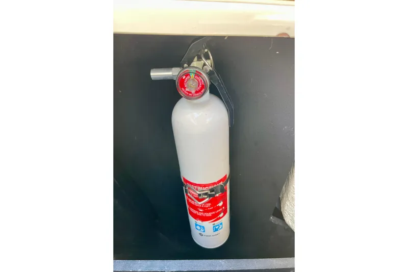 Slide: The Image of Fire extinguisher mounted on a 2016 Regal 23 OBX boat interior. - 27