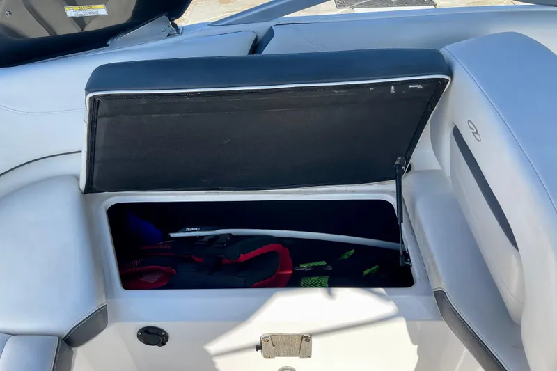 Slide: The Image of Open storage compartment in 2016 Regal 23 OBX boat, showing life jackets and equipment. - 28