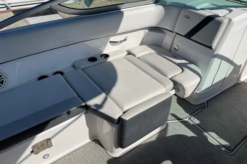 Slide: The Image of 2016 Regal 23 OBX boat interior with cushioned seating and cup holders. - 31