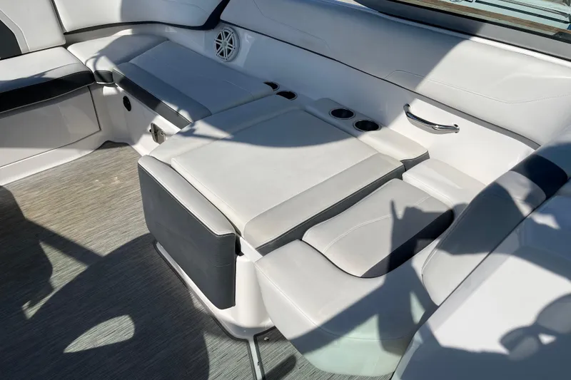 Slide: The Image of Interior seating of a 2016 Regal 23 OBX boat with cup holders and speaker. - 32