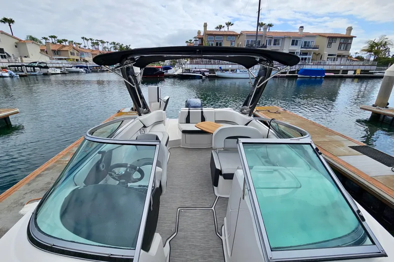 Slide: The Image of 2016 Regal 23 OBX boat docked in a marina with modern seating and canopy. - 35