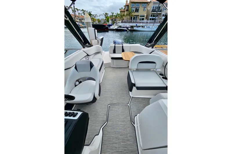 Slide: The Image of 2016 Regal 23 OBX boat interior with modern seating and waterfront view. - 36