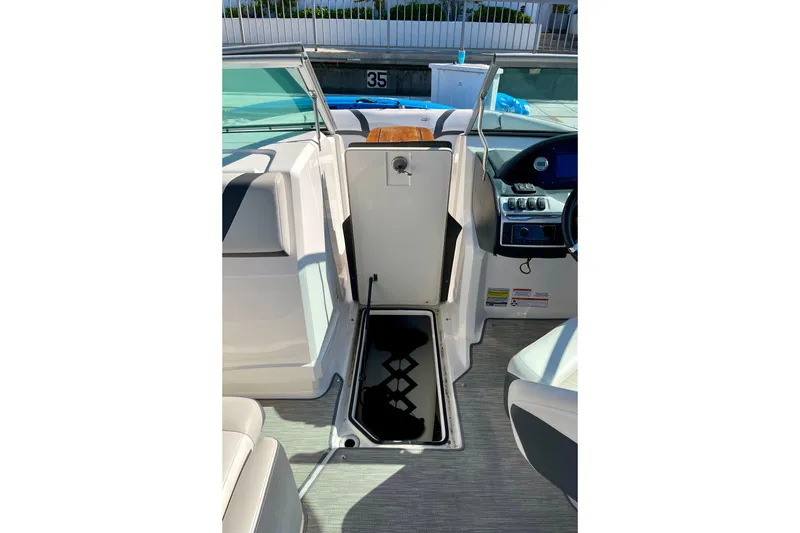 Slide: The Image of 2016 Regal 23 OBX boat interior with open storage compartment and seating. - 38