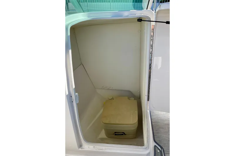 Slide: The Image of Compact bathroom area in 2016 Regal 23 OBX boat with portable toilet. - 40