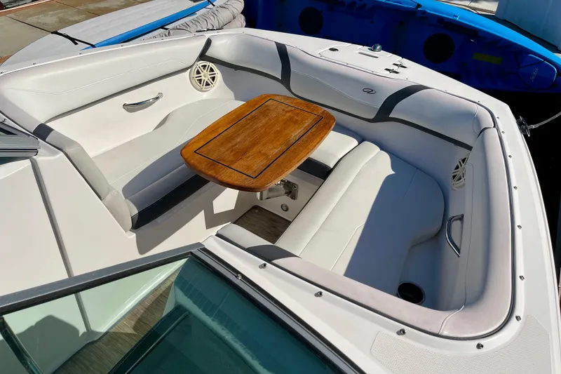 Slide: The Image of 2016 Regal 23 OBX boat interior with white seating and wooden table. - 41