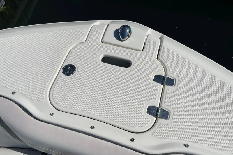Slide: The Image of 2016 Regal 23 OBX boat deck with storage compartment and latch. - 42