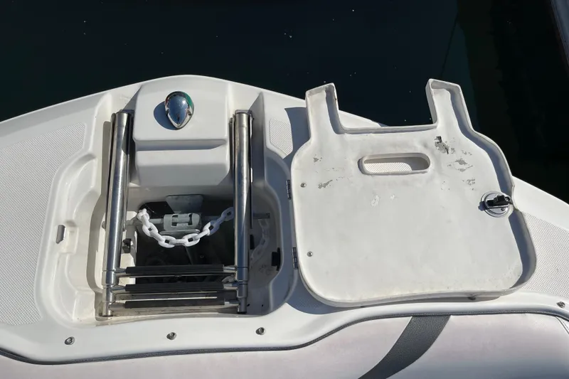 Slide: The Image of 2016 Regal 23 OBX boat anchor compartment with ladder and chain. - 43