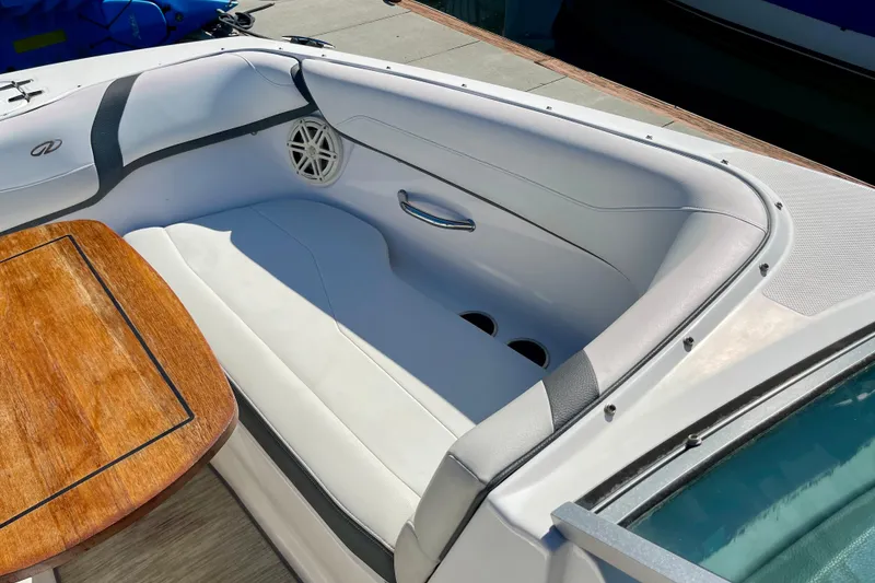 Slide: The Image of 2016 Regal 23 OBX boat interior with white seating and wooden table. - 47