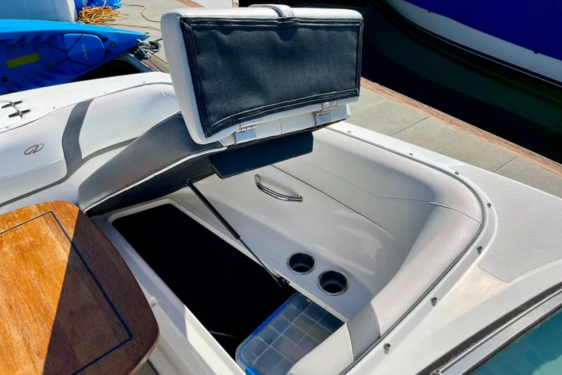 Slide: The Image of 2016 Regal 23 OBX boat interior with open storage compartment and cup holders. - 48