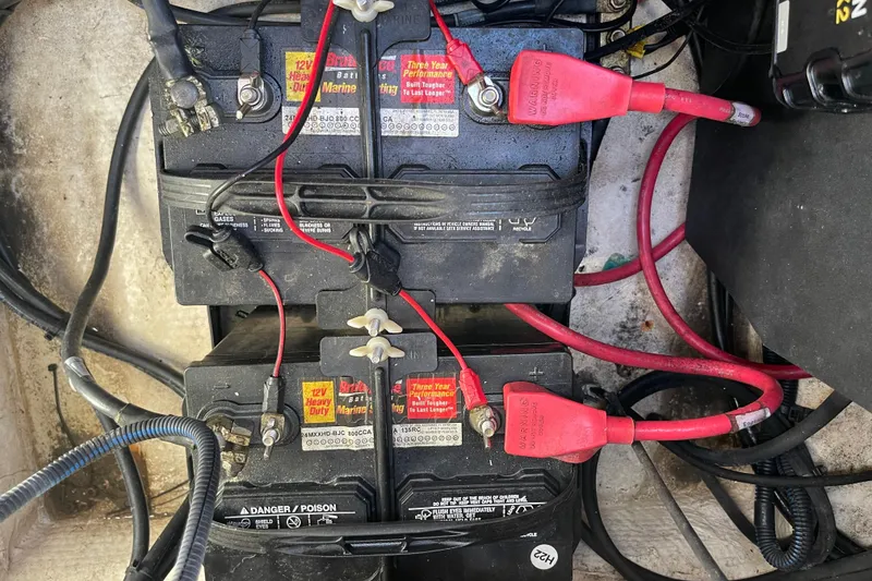Slide: The Image of Batteries in a 2016 Regal 23 OBX boat with red and black cables connected. - 53