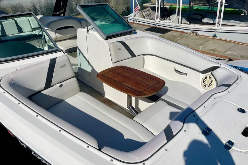 Slide: The Image of 2016 Regal 23 OBX boat interior with white seating and wooden table. - 7