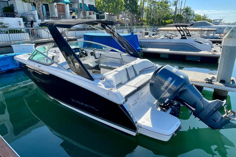 Slide: The Image of 2016 Regal 23 OBX boat docked, featuring sleek design and Yamaha outboard motor. - 8
