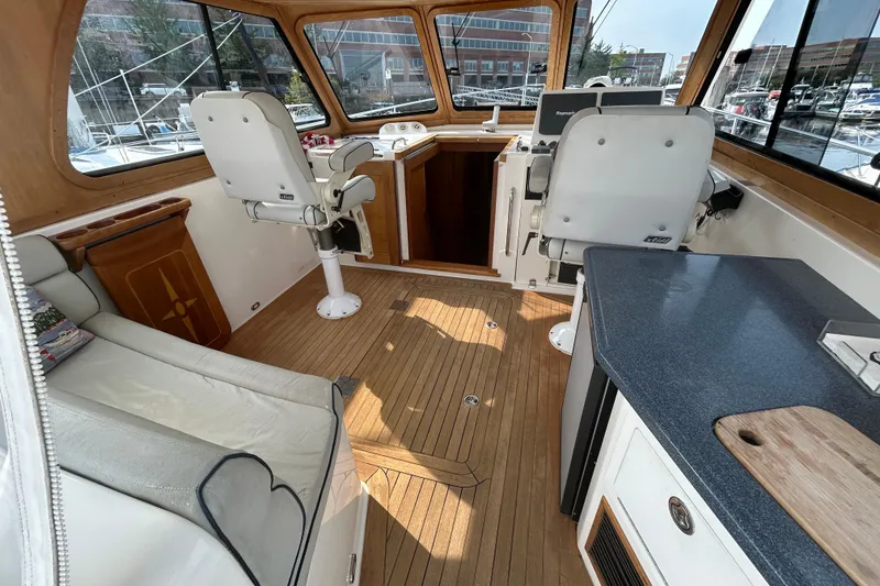 Slide: The Image of Interior of 2005 Sabre 38 yacht with wooden flooring and modern helm station. - 10
