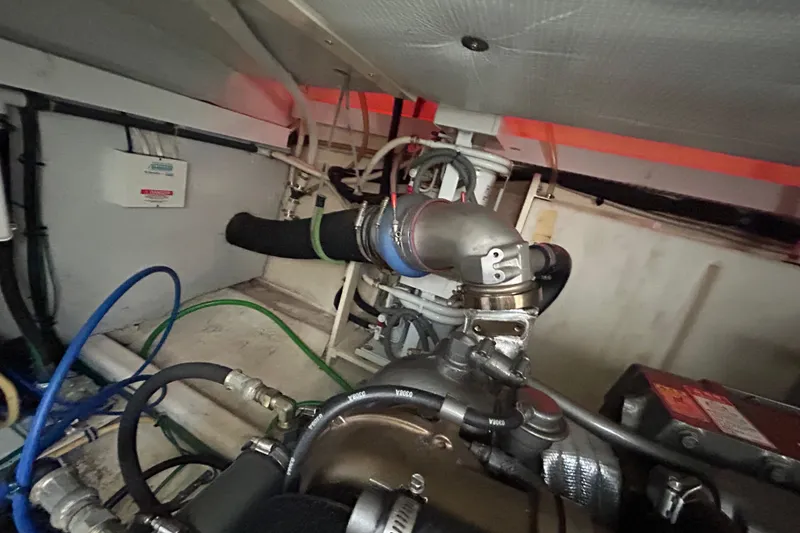 Slide: The Image of Engine compartment of a 2005 Sabre 38 boat, featuring hoses and mechanical components. - 20