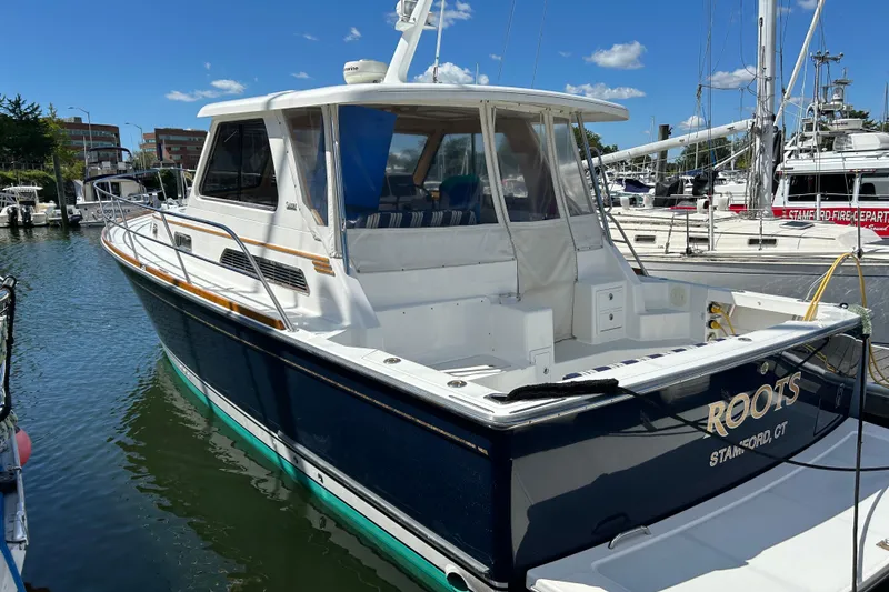 Slide: The Image of 2005 Sabre 38 yacht docked at marina under clear blue sky. - 3