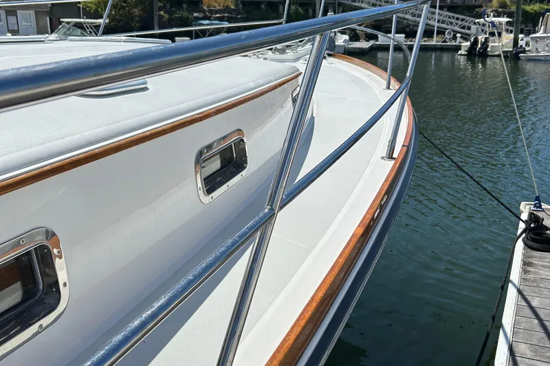 Slide: The Image of 2005 Sabre 38 yacht deck with polished railings and docked at marina. - 4