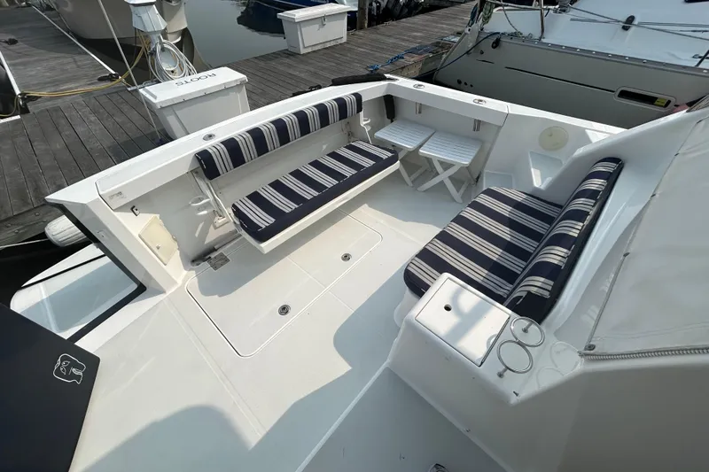 Slide: The Image of 2005 Sabre 38 yacht cockpit with striped seating and dock view. - 8