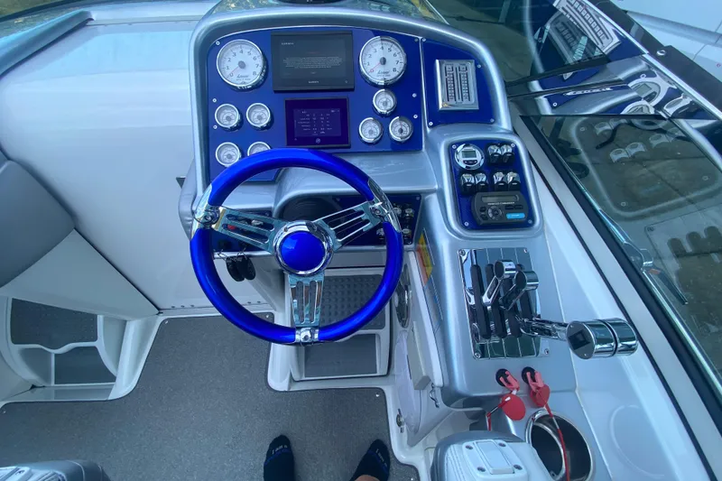 Slide: The Image of 2008 Formula 382 FASTech boat cockpit with blue steering wheel and control panel. - 15