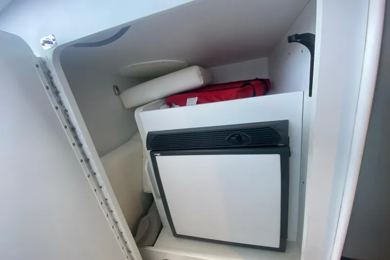 Slide: The Image of 2008 Formula 382 FASTech interior storage with mini fridge and red bag. - 27