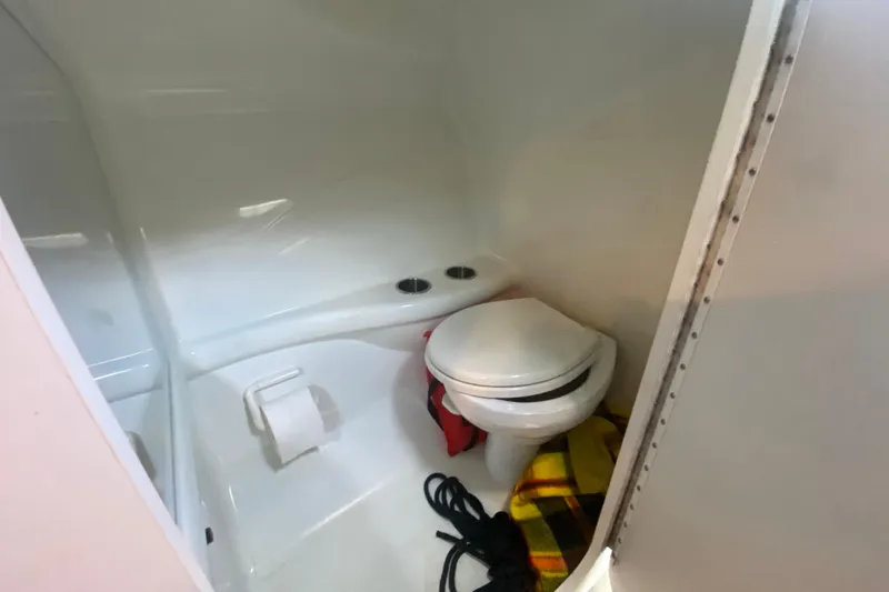 Slide: The Image of 2008 Formula 382 FASTech boat bathroom with toilet, paper holder, and storage items. - 29
