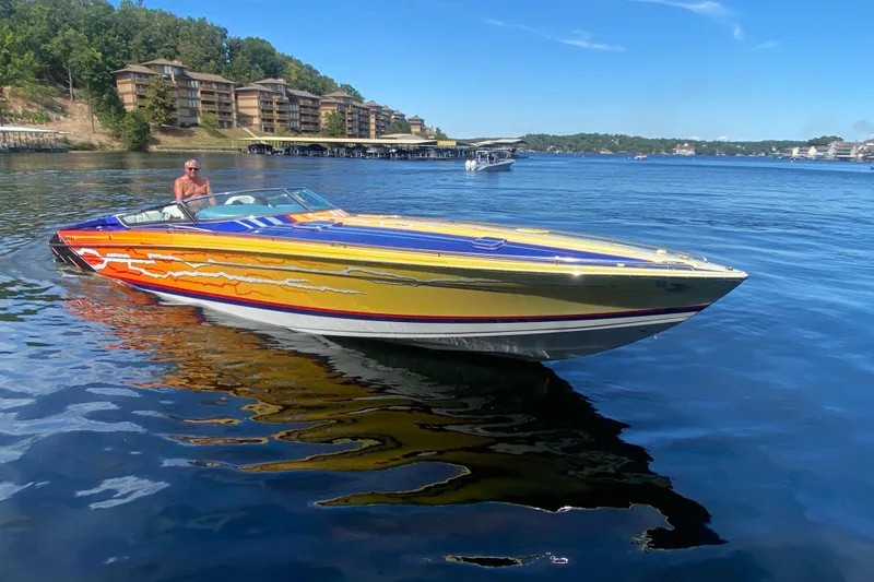 Slide: The Image of 2008 Formula 382 FASTech speedboat on a lake with vibrant graphics and scenic background. - 36