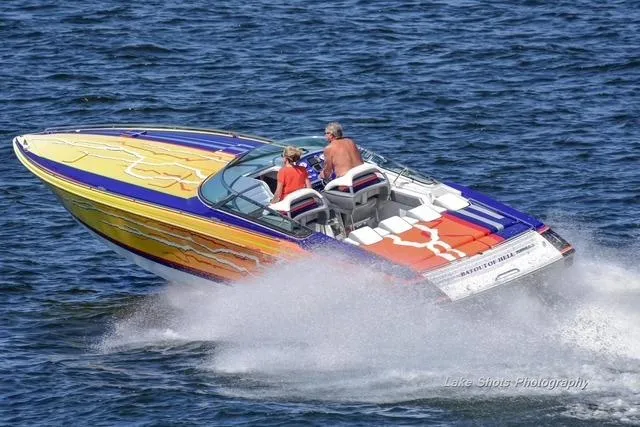 Slide: The Image of 2008 Formula 382 FASTech speedboat with vibrant design cruising on open water. - 37