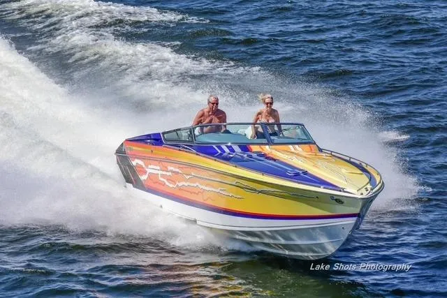 Slide: The Image of 2008 Formula 382 FASTech speedboat with vibrant graphics cruising on open water. - 38