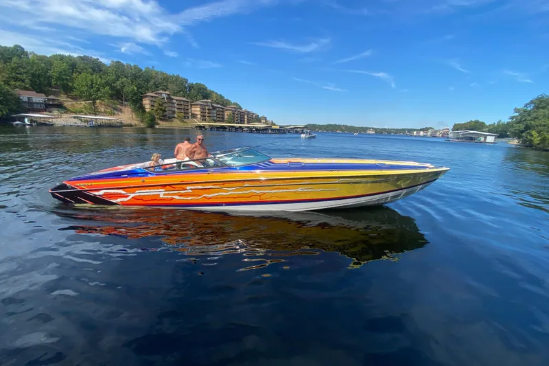 Slide: The Image of 2008 Formula 382 FASTech boat with vibrant design on a scenic lake. - 6