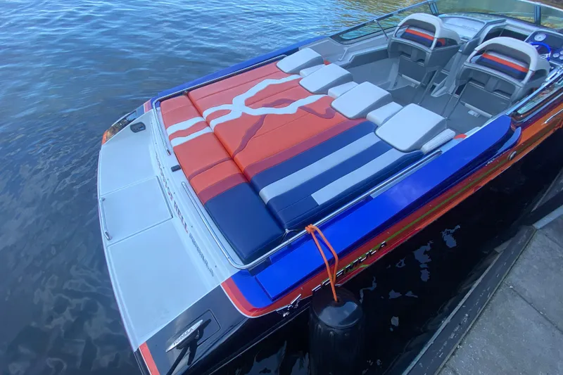 Slide: The Image of 2008 Formula 382 FASTech boat with vibrant seating, docked on calm water. - 7