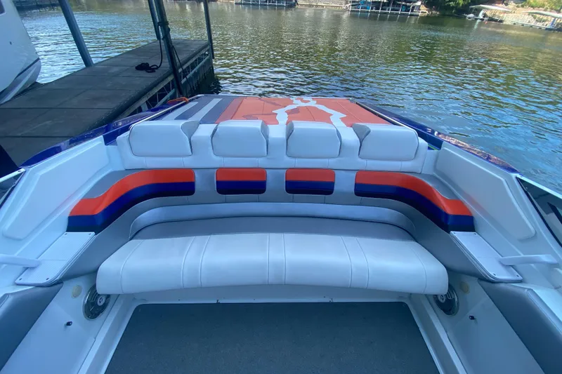 Slide: The Image of 2008 Formula 382 FASTech boat interior with colorful seating by the water. - 8