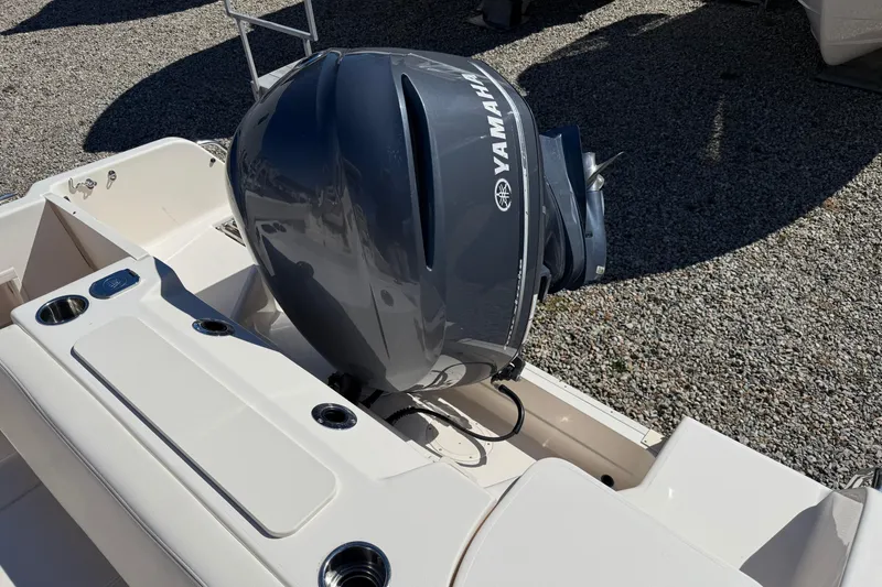 Slide: The Image of 2015 Grady-White Journey 258 boat with Yamaha outboard motor, parked on gravel. - 10