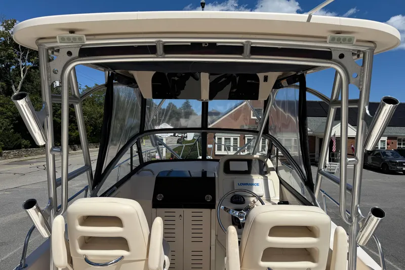 Slide: The Image of 2015 Grady-White Journey 258 boat interior with steering console and rod holders. - 3
