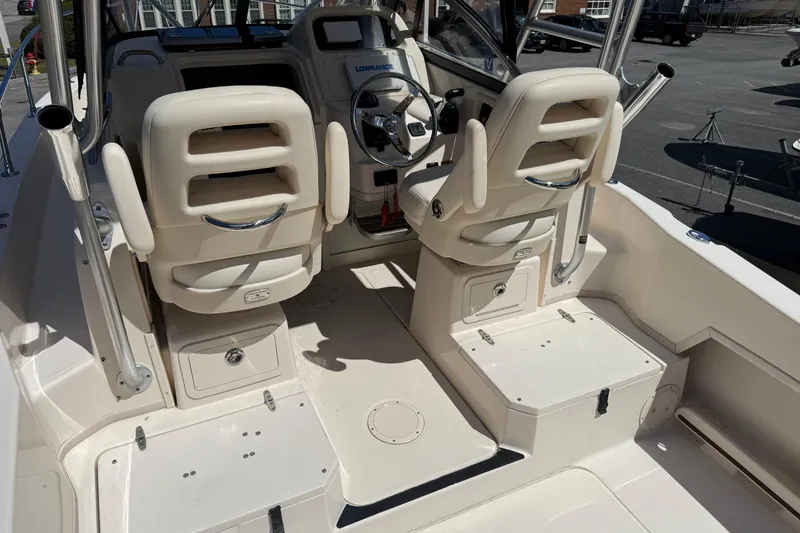 Slide: The Image of 2015 Grady-White Journey 258 boat interior with dual helm seats and steering wheel. - 4
