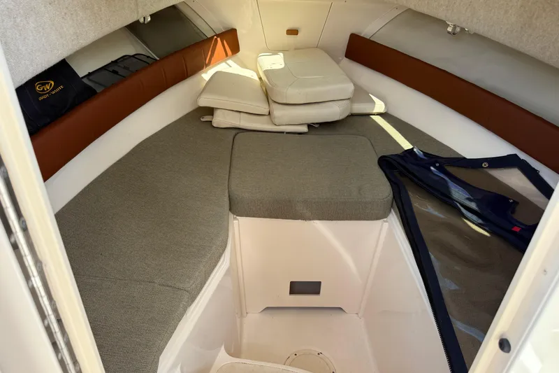 Slide: The Image of 2015 Grady-White Journey 258 cabin interior with cushions and storage. - 7