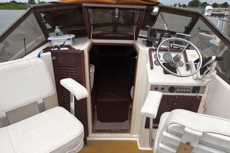 Slide: The Image of 1982 Mako 228 boat interior with steering wheel, seating, and control panel. - 10