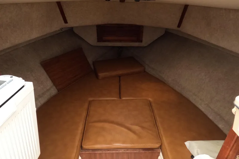 Slide: The Image of Interior cabin of a 1982 Mako 228 boat with brown cushions and wood accents. - 14