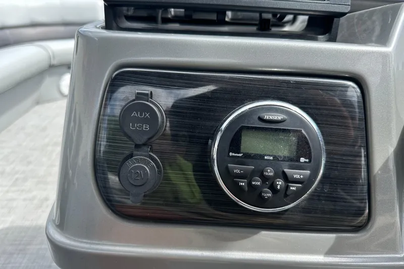 Slide: The Image of Control panel of 2019 Lowe SS270 boat with Jensen audio system and AUX/USB ports. - 14