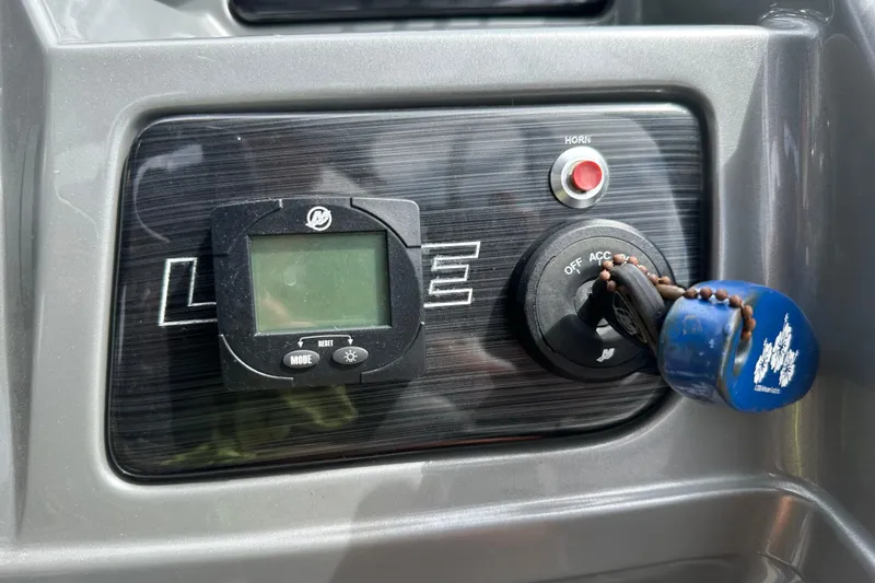Slide: The Image of Control panel of 2019 Lowe SS270 Extended Walk-Thru boat with ignition and digital display. - 15