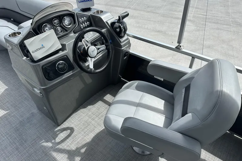 Slide: The Image of 2019 Lowe SS270 Extended Walk-Thru boat helm with Garmin navigation system and comfortable captain's chair. - 18
