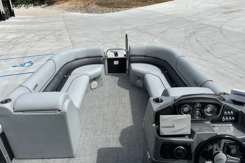 Slide: The Image of 2019 Lowe SS270 Extended Walk-Thru pontoon boat with spacious seating and modern dashboard. - 20