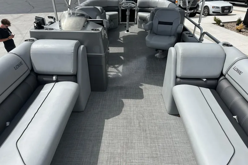 Slide: The Image of 2019 Lowe SS270 Extended Walk-Thru pontoon boat interior with gray seating and spacious layout. - 21