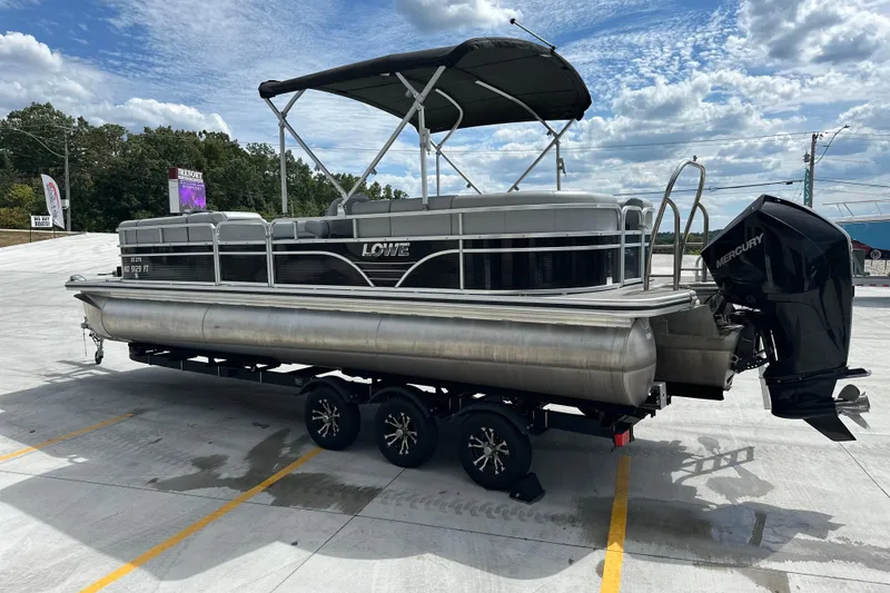Slide: The Image of 2019 Lowe SS270 Extended Walk-Thru pontoon boat on trailer, under cloudy sky. - 3