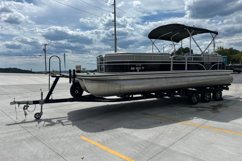 Slide: The Image of 2019 Lowe SS270 Extended Walk-Thru pontoon boat on trailer under cloudy sky. - 5