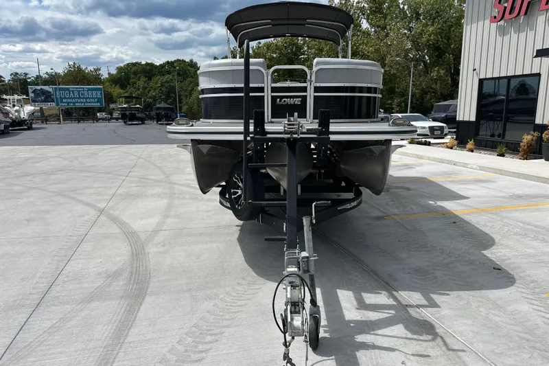 Slide: The Image of 2019 Lowe SS270 Extended Walk-Thru pontoon boat on trailer in parking lot. - 6