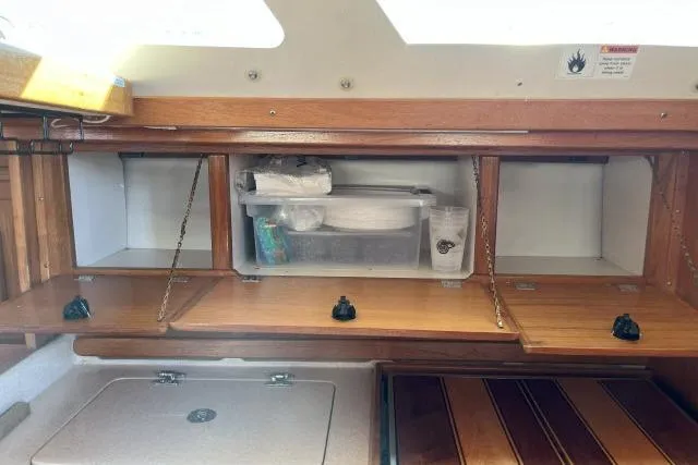 Slide: The Image of Interior storage of 2000 Catalina 34 Mk II sailboat with wooden cabinets and shelves. - 10